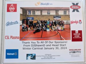 A large group of children and adults gather in a gymnasium for a group photo at the Head Start Winter Carnival on January 30, 2024. The image features sponsor logos, including Walmart, Arby’s, Culver’s, Wendy’s, CSL Plasma, Pizza X, BioLife, IU Surplus Store Bloomington, and Rose & Walker.